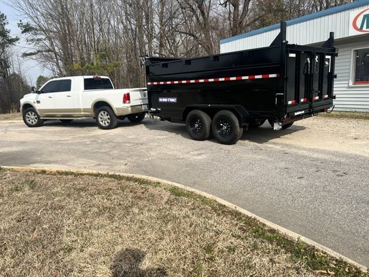 Pickup and trailer in a commercial parking lot for a cleanout