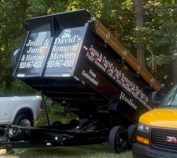 Raised dump trailer showing the company lettering